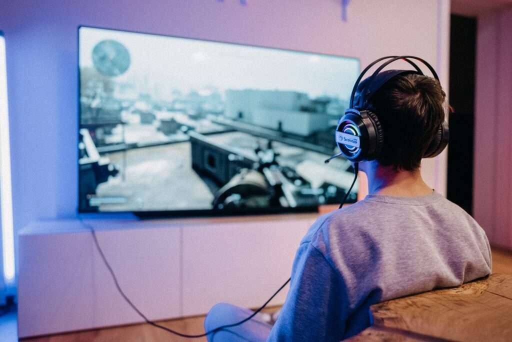 Man playing video game on big tv in the living room